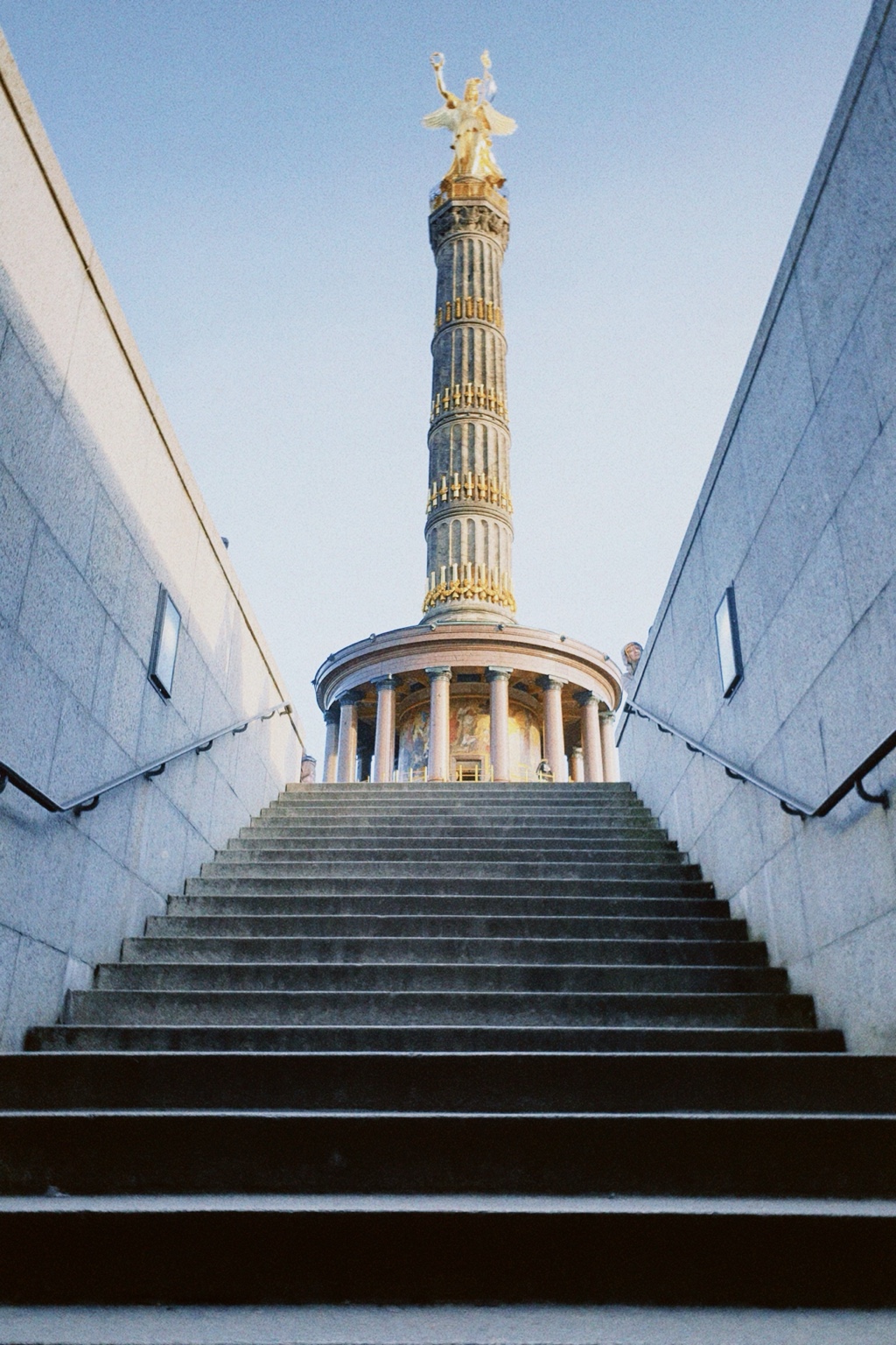 The Berlin Victory Column with the gilded Victoria statue viewed from a broad staircase.