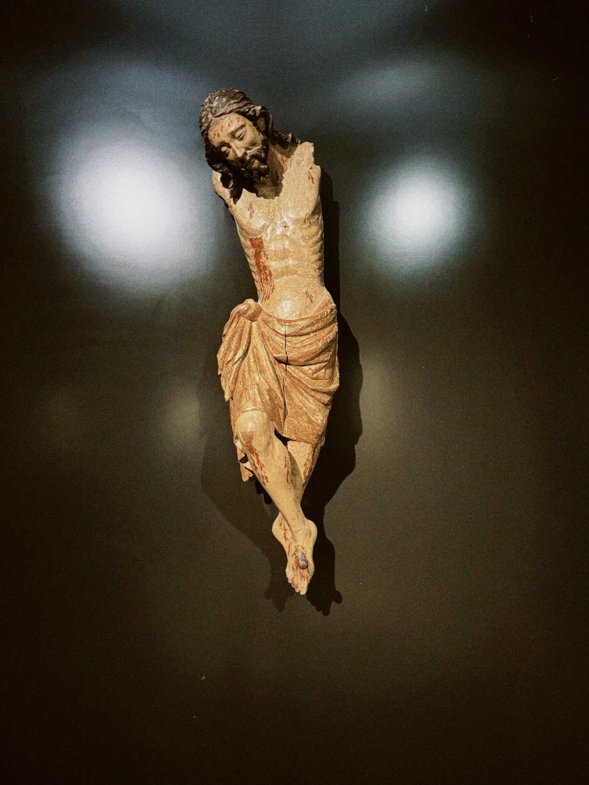 A historic crucifix sculpture displayed at the Rijksmuseum in Amsterdam, Netherlands.
